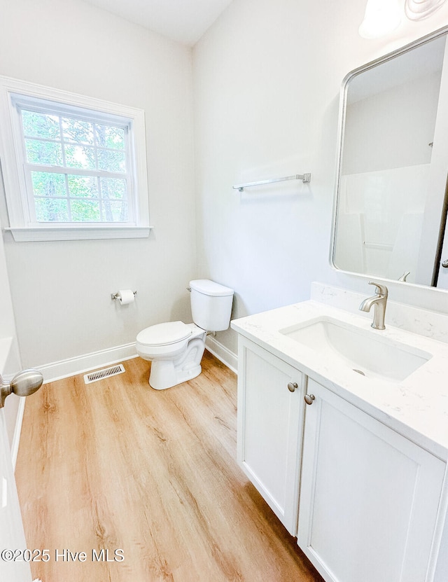 135 Live Oak Dr, Leland, NC 28451 - bathroom with toilet, baseboards, visible vents, and wood finished floors