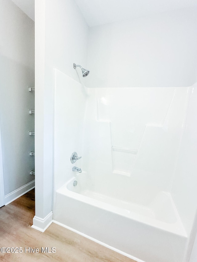 135 Live Oak Dr, Leland, NC 28451 - bathroom featuring baseboards, shower / bathtub combination, and wood finished floors