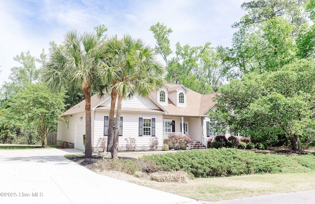 135 Live Oak Dr, Leland, NC 28451 - cape cod house featuring concrete driveway, a garage, and fence