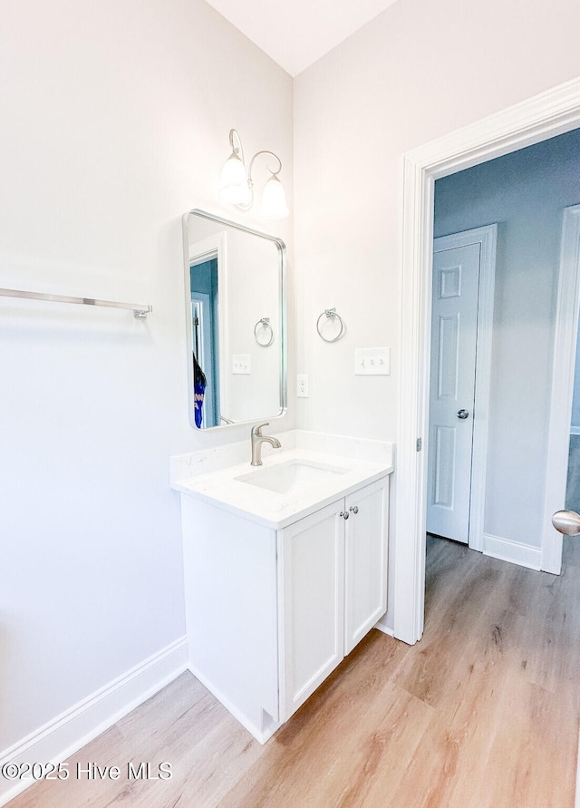 135 Live Oak Dr, Leland, NC 28451 - bathroom with baseboards, vanity, and wood finished floors