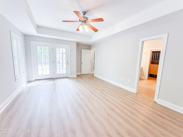 135 Live Oak Dr, Leland, NC 28451 - interior space featuring a tray ceiling, wood finished floors, baseboards, and a ceiling fan