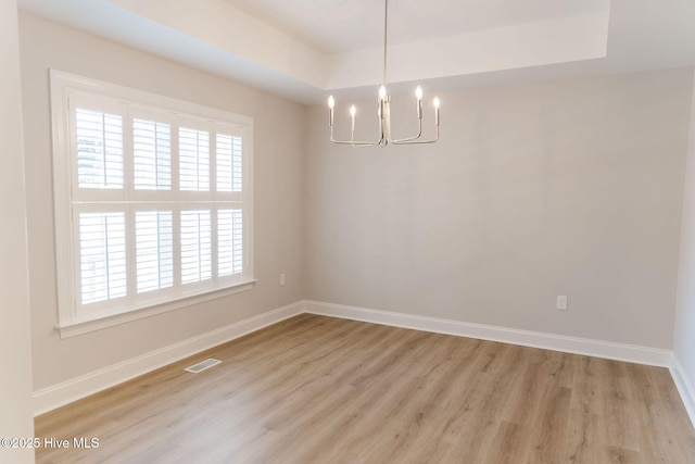 135 Live Oak Dr, Leland, NC 28451 - unfurnished room with light wood-style flooring, a notable chandelier, baseboards, and plenty of natural light