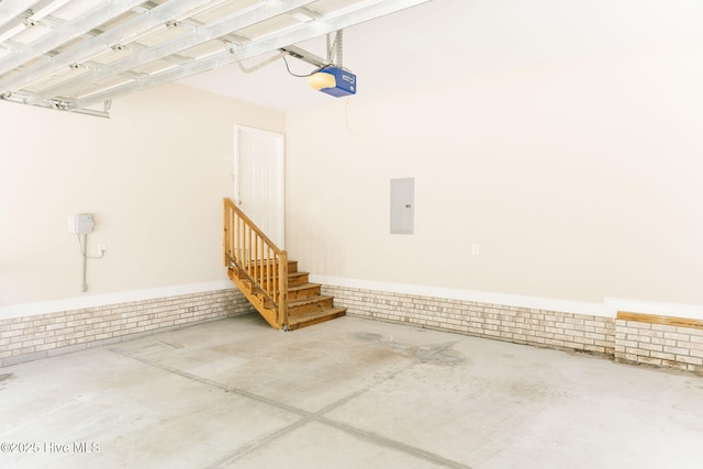 135 Live Oak Dr, Leland, NC 28451 - garage featuring electric panel, wainscoting, and a garage door opener