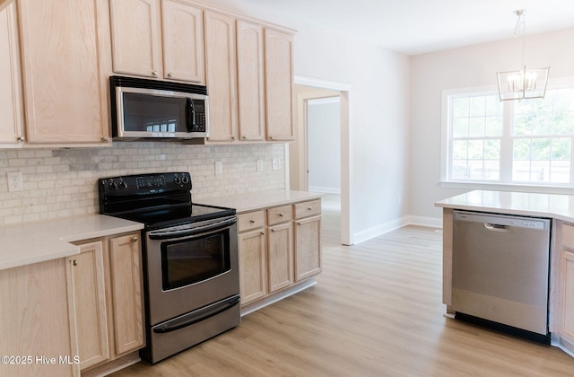 135 Live Oak Dr, Leland, NC 28451 - kitchen featuring light brown cabinetry, stainless steel appliances, decorative backsplash, light countertops, and light wood-type flooring