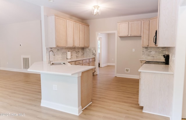 135 Live Oak Dr, Leland, NC 28451 - kitchen with a sink, a peninsula, backsplash, and visible vents