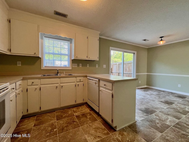 kitchen featuring white appliances, a sink, ornamental molding, a peninsula, and a textured ceiling