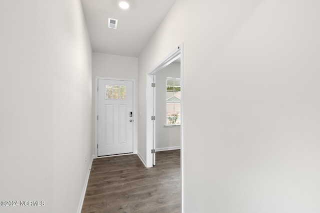 doorway featuring baseboards, recessed lighting, wood finished floors, and visible vents