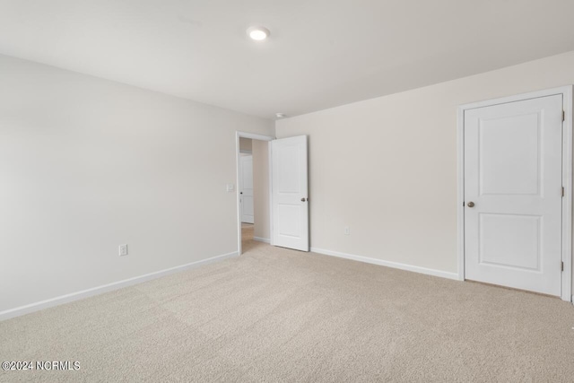 unfurnished bedroom with baseboards, recessed lighting, and light colored carpet