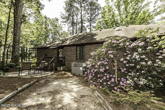 7730 Old Raleigh Rd, Bailey, NC 27807 - view of property exterior with a patio area, brick siding, and a shingled roof