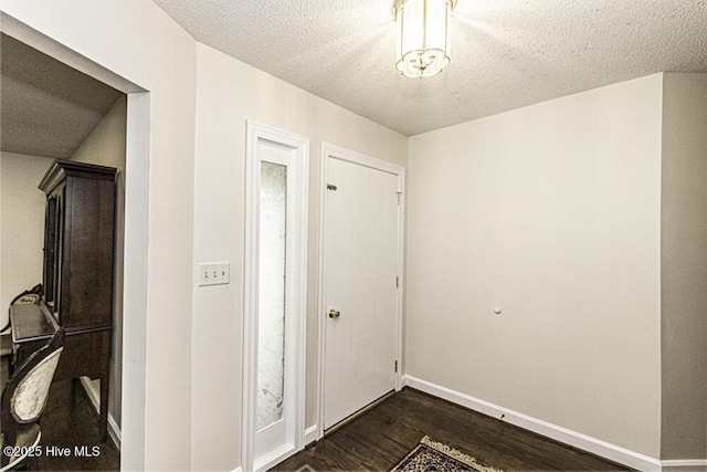 7730 Old Raleigh Rd, Bailey, NC 27807 - foyer entrance with a textured ceiling, baseboards, and dark wood-style floors