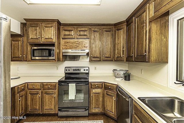 7730 Old Raleigh Rd, Bailey, NC 27807 - kitchen featuring dark brown cabinets, light countertops, stainless steel appliances, and under cabinet range hood