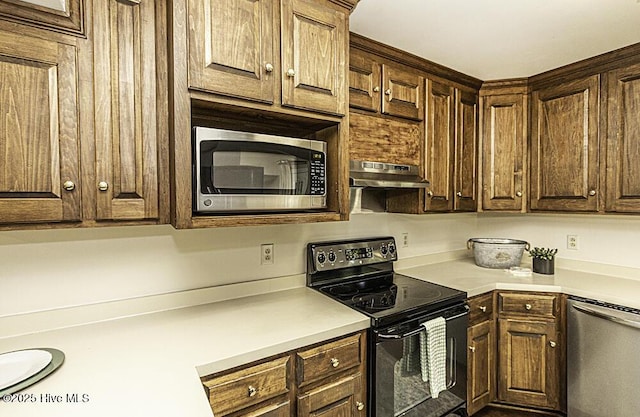 7730 Old Raleigh Rd, Bailey, NC 27807 - kitchen with under cabinet range hood, light countertops, stainless steel appliances, and dark brown cabinets