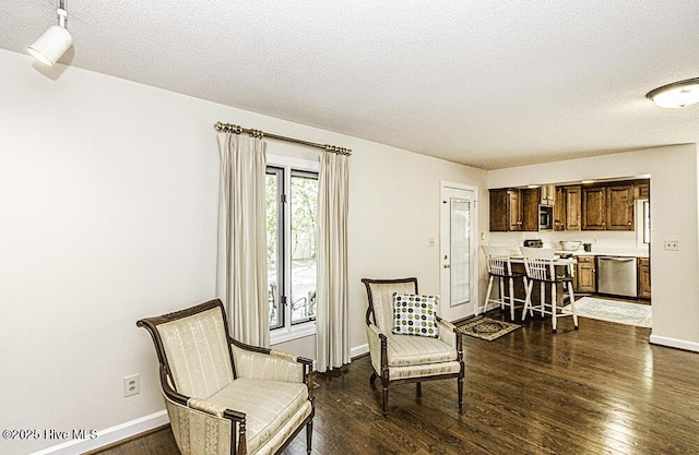 7730 Old Raleigh Rd, Bailey, NC 27807 - sitting room featuring dark wood finished floors, a textured ceiling, and baseboards