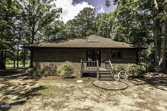 7730 Old Raleigh Rd, Bailey, NC 27807 - view of front of house featuring a wooden deck, french doors, and brick siding