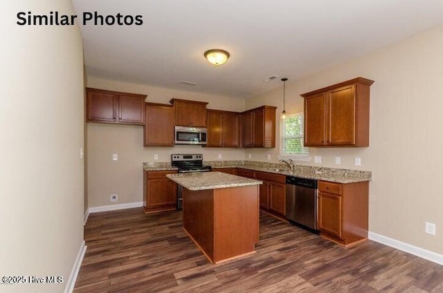 153 Tides End Dr, Holly Ridge, NC 28445 - kitchen with appliances with stainless steel finishes, a sink, dark wood finished floors, and a center island