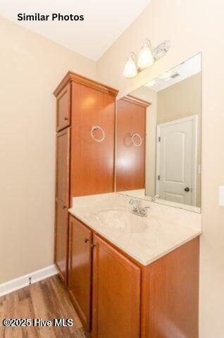 153 Tides End Dr, Holly Ridge, NC 28445 - bathroom featuring wood finished floors, vanity, and baseboards