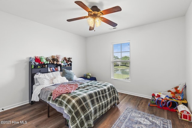 bedroom with ceiling fan, baseboards, visible vents, and wood finished floors