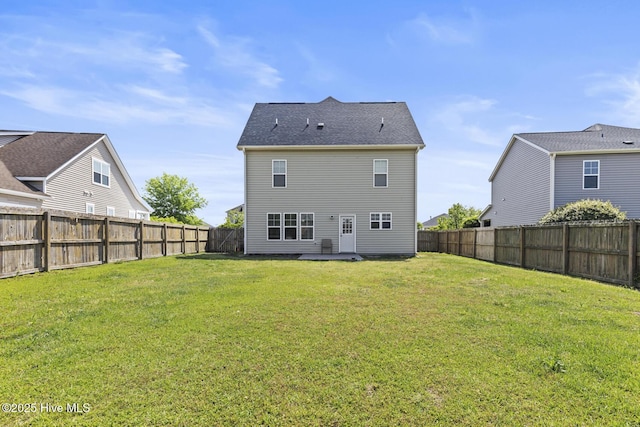 back of property with a fenced backyard, a patio, and a yard