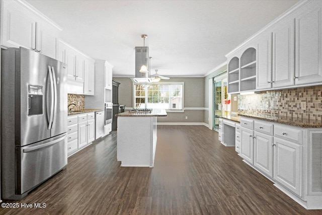 kitchen featuring baseboards, tasteful backsplash, white cabinets, and stainless steel appliances