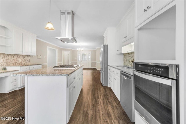 kitchen with extractor fan, a center island, white cabinetry, a sink, and appliances with stainless steel finishes