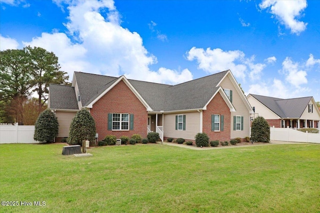 ranch-style house with fence, a front lawn, and brick siding