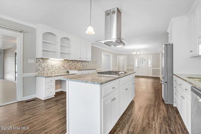 kitchen featuring appliances with stainless steel finishes, range hood, a center island, and white cabinets