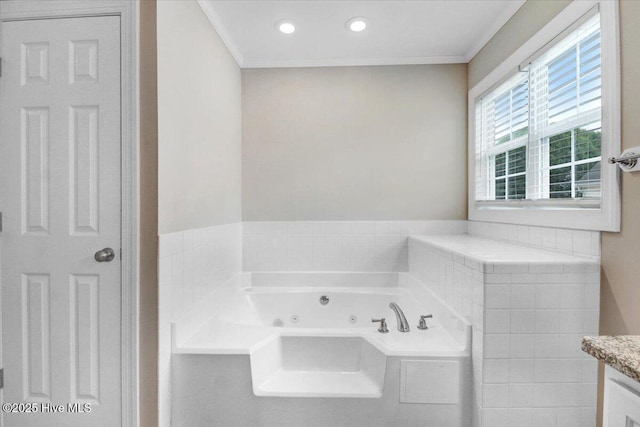 full bath featuring crown molding, a whirlpool tub, and vanity
