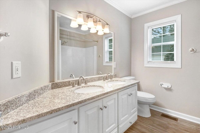 bathroom featuring a sink, baseboards, toilet, and visible vents