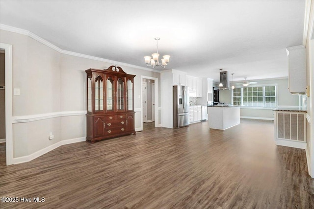 unfurnished living room with baseboards, a notable chandelier, dark wood-style floors, and ornamental molding