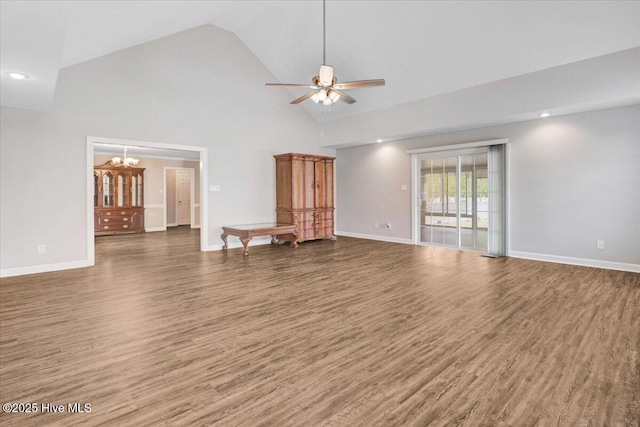 unfurnished living room featuring high vaulted ceiling, baseboards, ceiling fan with notable chandelier, and wood finished floors