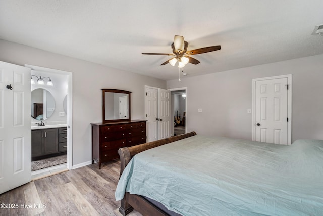 bedroom with a ceiling fan, light wood finished floors, and connected bathroom