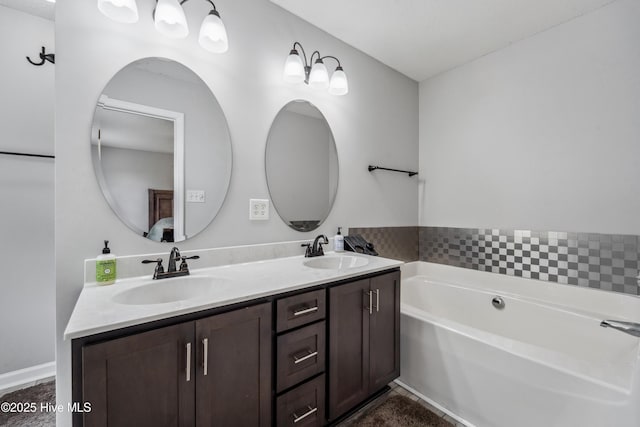 bathroom featuring a garden tub, a sink, and double vanity