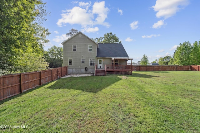 back of house featuring a fenced backyard, a wooden deck, and a yard
