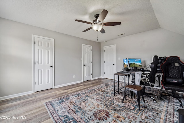 office area with baseboards, ceiling fan, a textured ceiling, and wood finished floors