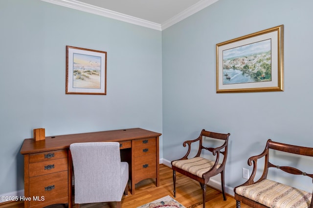 office area featuring ornamental molding, baseboards, and wood finished floors