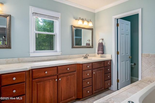 bathroom with crown molding, a tub to relax in, and vanity
