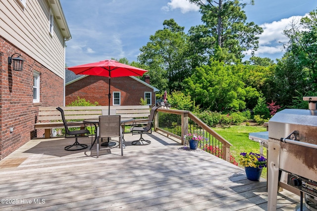 wooden deck featuring area for grilling and outdoor dining space