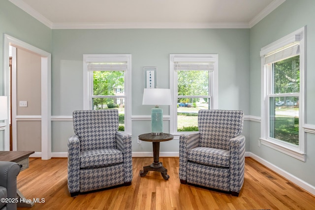 sitting room with plenty of natural light and wood finished floors