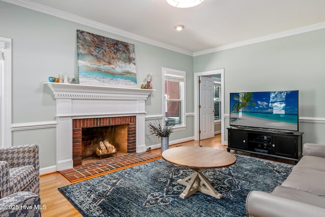 living area featuring ornamental molding, a brick fireplace, and wood finished floors