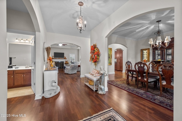 503 Shipyard Ct, Swansboro, NC 28584 - entrance foyer with crown molding, a notable chandelier, arched walkways, baseboards, and wood finished floors