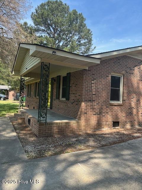 714 S Brown Rd, Enfield, NC 27823 - view of side of home featuring a porch, brick siding, and crawl space