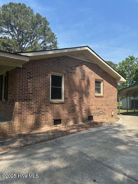 714 S Brown Rd, Enfield, NC 27823 - view of side of home with brick siding, crawl space, and a carport