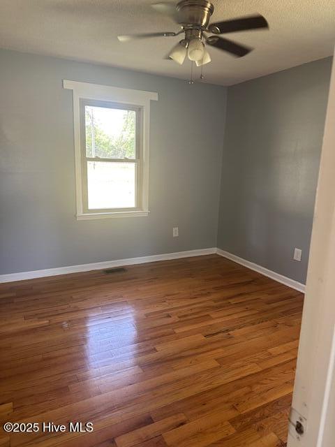 714 S Brown Rd, Enfield, NC 27823 - unfurnished room featuring baseboards, ceiling fan, and wood finished floors