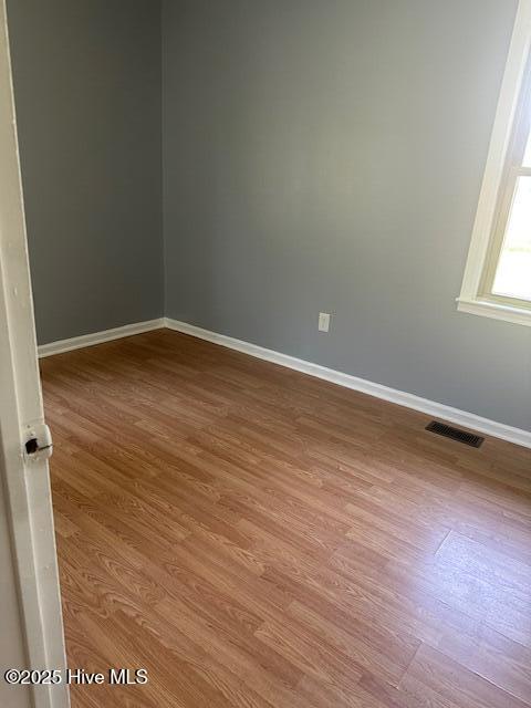 714 S Brown Rd, Enfield, NC 27823 - unfurnished room with baseboards, visible vents, and wood finished floors