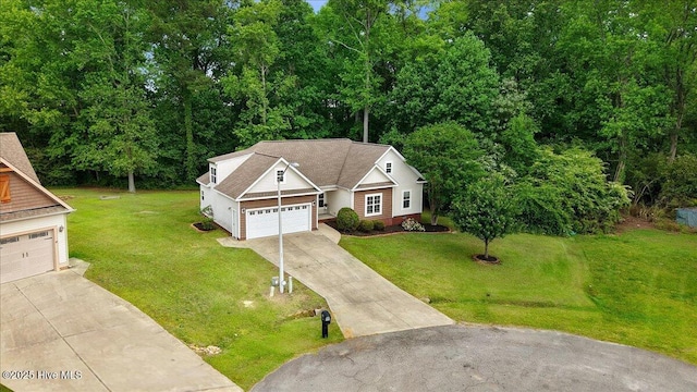 view of front of home with a garage, driveway, and a front lawn