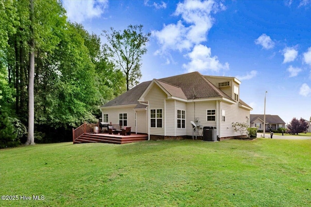rear view of house featuring a lawn, central AC, and a deck