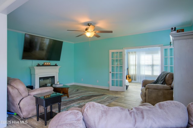 108 Nellie Ln, Swansboro, NC 28584 - living room with a glass covered fireplace, baseboards, a ceiling fan, and wood finished floors