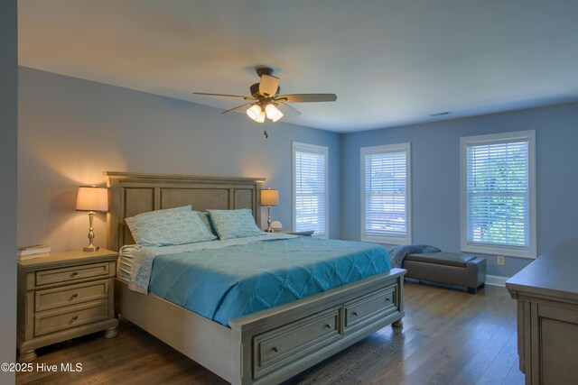 108 Nellie Ln, Swansboro, NC 28584 - bedroom with baseboards, dark wood-style flooring, and ceiling fan