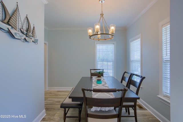 108 Nellie Ln, Swansboro, NC 28584 - dining room featuring baseboards, a chandelier, ornamental molding, and wood finished floors