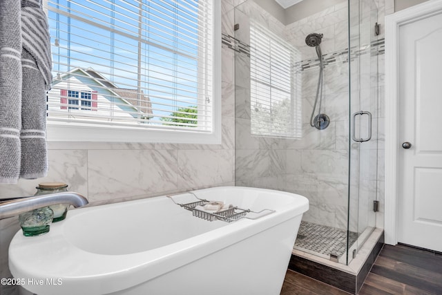 167 Fallbrook Ln, Rocky Point, NC 28457 - full bathroom with wood finished floors, a freestanding bath, a stall shower, and tile walls